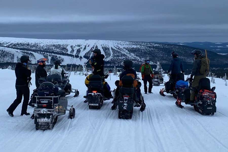 Groep mensen op de sneeuwscooter op de bergen in Sälen